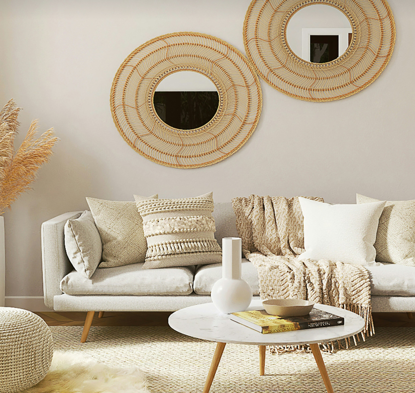 Boho chic living room featuring wicker mirrors, soft textures, and natural tones for a cozy and inviting feel.