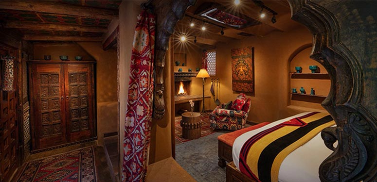 Rustic, southwestern-inspired bedroom with warm tones, patterned textiles, and traditional wooden decor.